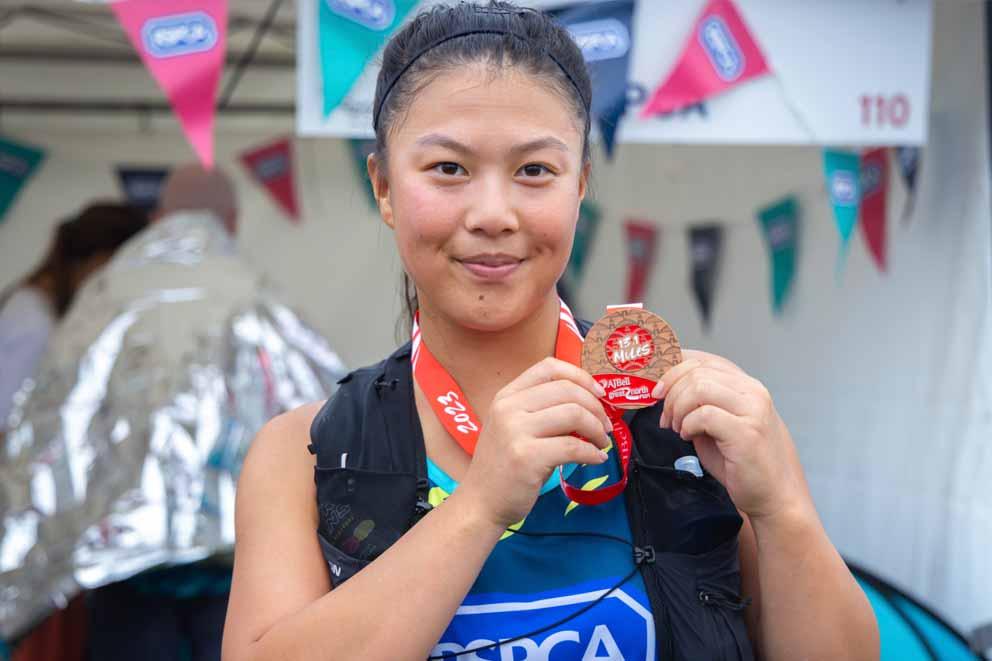 RSPCA fundraiser Cherisay Juillet with her finisher's medal at the RSPCA hospitality reception tent in the charity village at the course finish in South Shields.