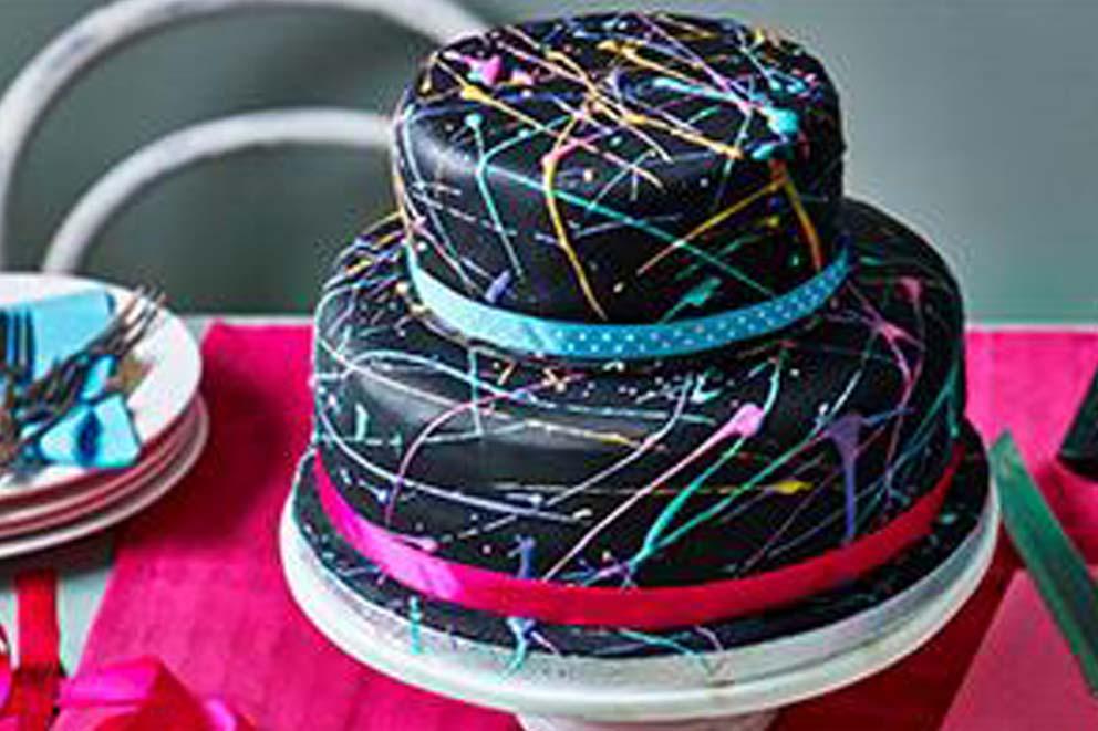 A two-tiered birthday cake ready to slice on a table.