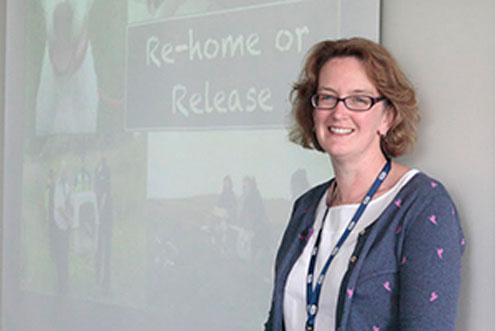 volunteer speaking in front of a powerpoint