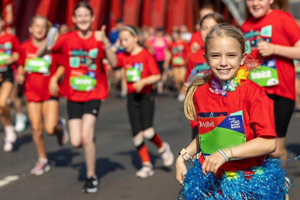 Smiling children running in a junior charity fundraiser.